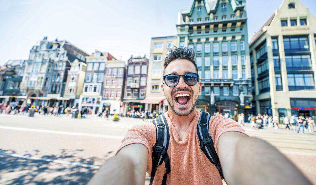 Happy tourist taking selfie picture in Amsterdam, Netherlands
